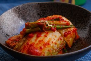 Close up image of kimchi as an example of a probiotic food that can help heal leaky gut.
