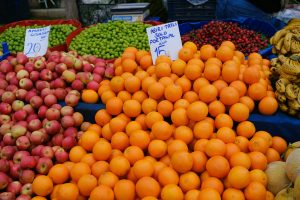A fruit stand full of apples and oranges to represent how to restore gut health after antiobiotics.
