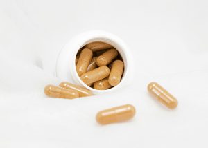 A pill bottle with supplements for gut health.